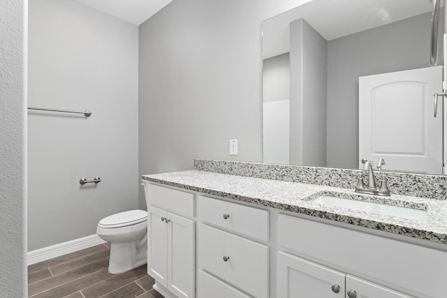 bathroom with toilet and vanity