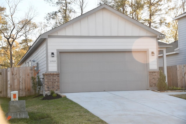 view of front of house with a garage and an outbuilding