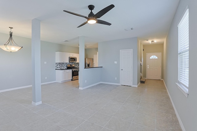 unfurnished living room featuring ceiling fan and light tile patterned floors