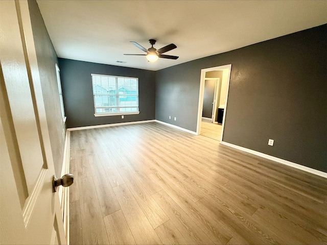 unfurnished bedroom with ceiling fan and light hardwood / wood-style flooring