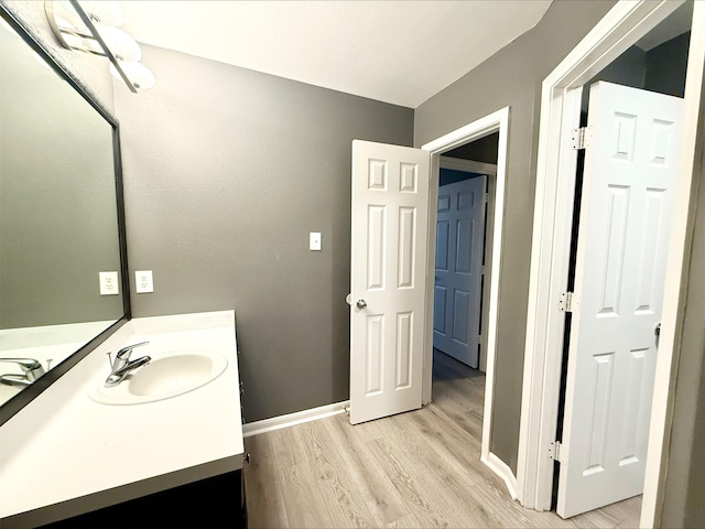 bathroom with vanity and hardwood / wood-style flooring