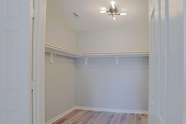 spacious closet featuring light hardwood / wood-style floors