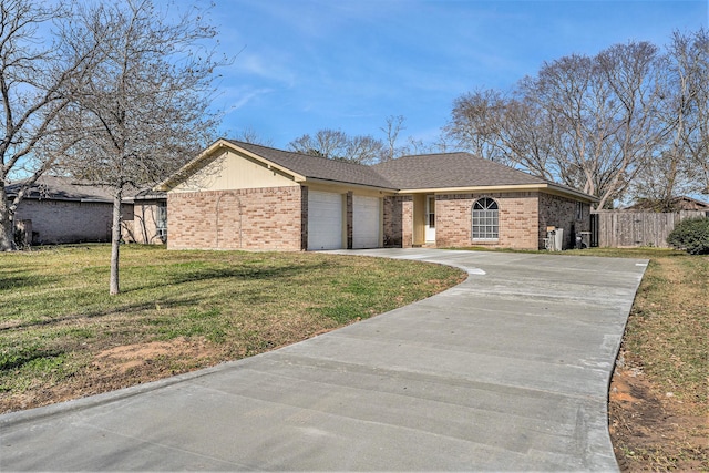 single story home with a garage and a front lawn