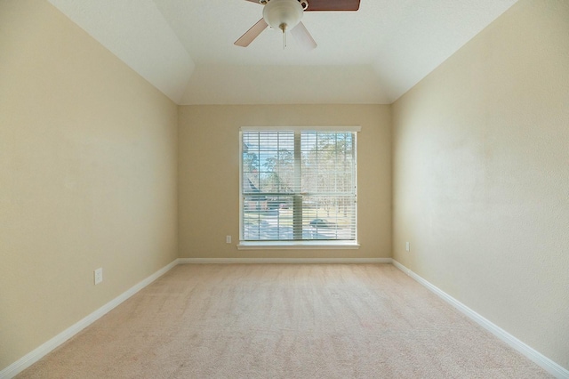 unfurnished room with a ceiling fan, lofted ceiling, light colored carpet, and baseboards