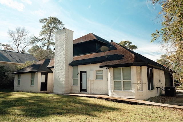 27210 Afton Way, Huffman, TX 77336 - back of house with a chimney, brick siding, a yard, and roof with shingles