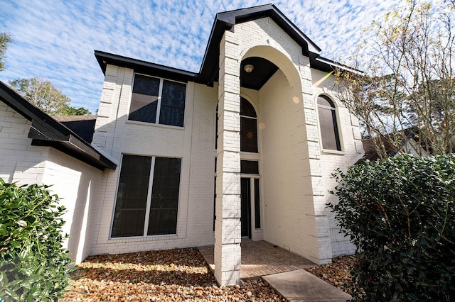 exterior space with brick siding