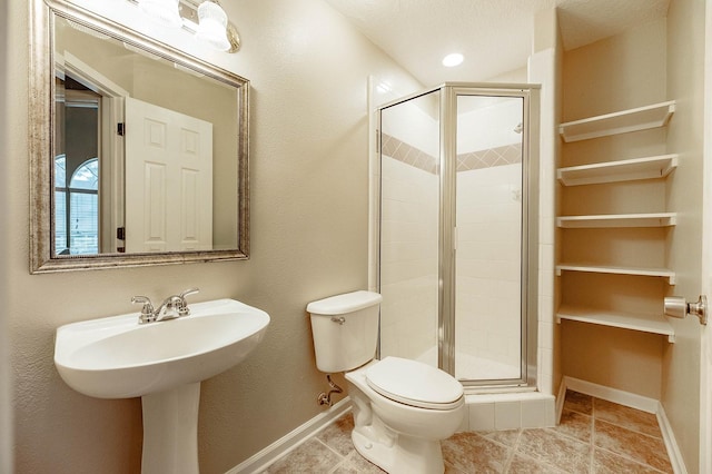 full bathroom with a stall shower, tile patterned flooring, baseboards, and toilet