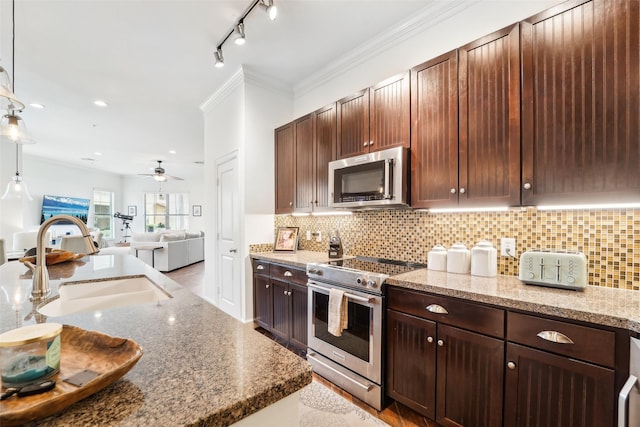 kitchen with ceiling fan, stainless steel appliances, decorative backsplash, pendant lighting, and sink