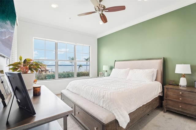 carpeted bedroom featuring ceiling fan and crown molding