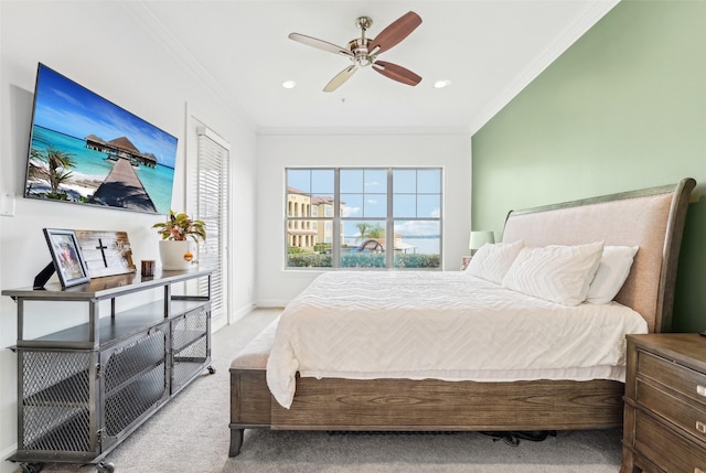 carpeted bedroom featuring ceiling fan and crown molding