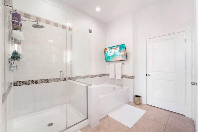 bathroom featuring tile patterned flooring and shower with separate bathtub