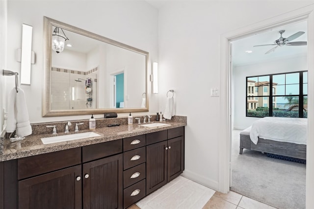 bathroom featuring ceiling fan, vanity, a shower with door, and tile patterned floors