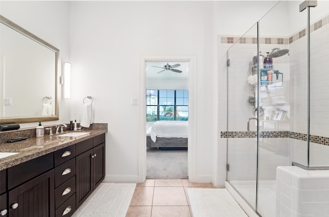 bathroom with ceiling fan, tile patterned flooring, a shower with door, and vanity