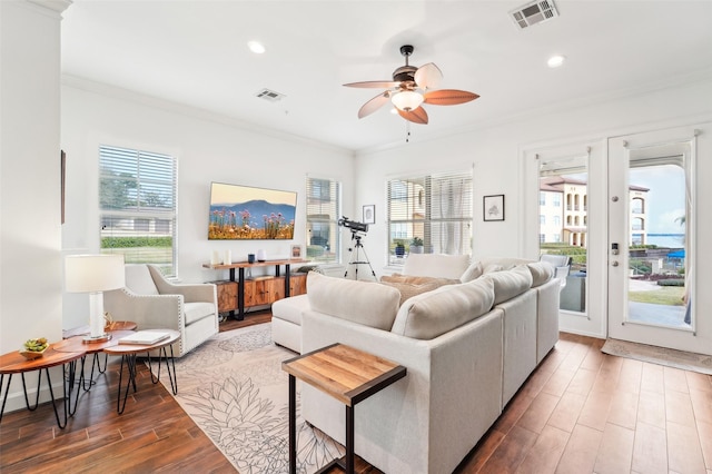 living room with ceiling fan, ornamental molding, a healthy amount of sunlight, and french doors