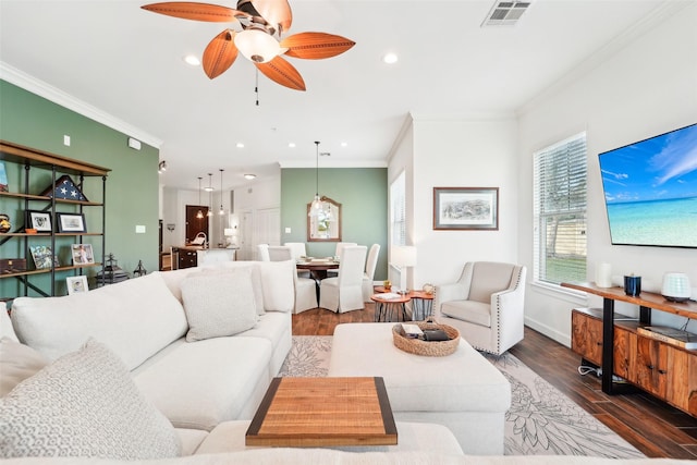 living room with ceiling fan, dark hardwood / wood-style floors, and ornamental molding