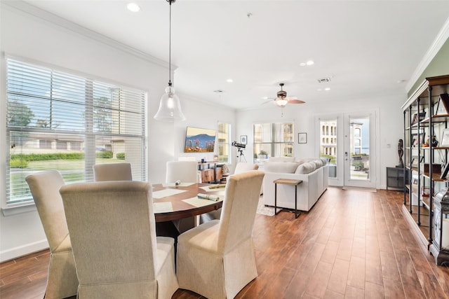 dining area with ceiling fan, crown molding, and hardwood / wood-style flooring