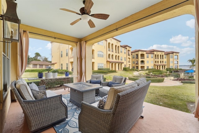 view of patio / terrace featuring ceiling fan and an outdoor fire pit