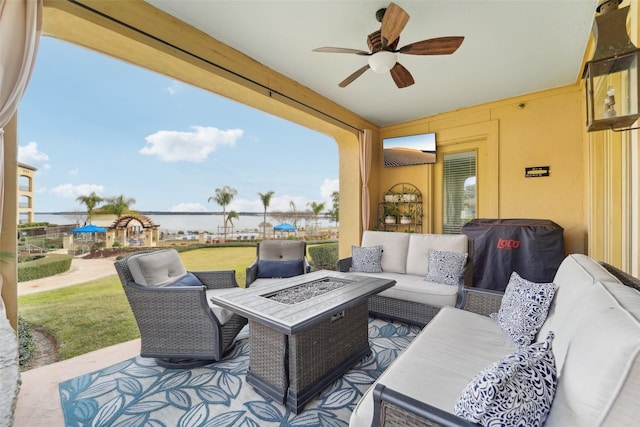 view of patio / terrace with a water view, an outdoor living space with a fire pit, and area for grilling