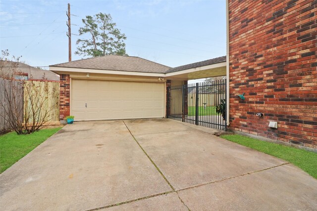 view of front of property with brick siding, an attached garage, a shingled roof, fence, and driveway