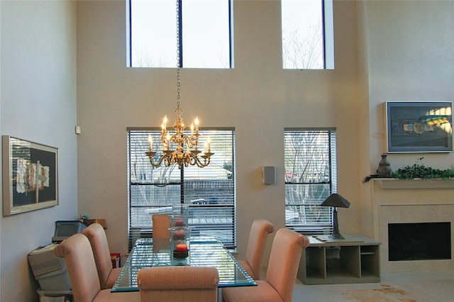 dining area with a chandelier and a towering ceiling