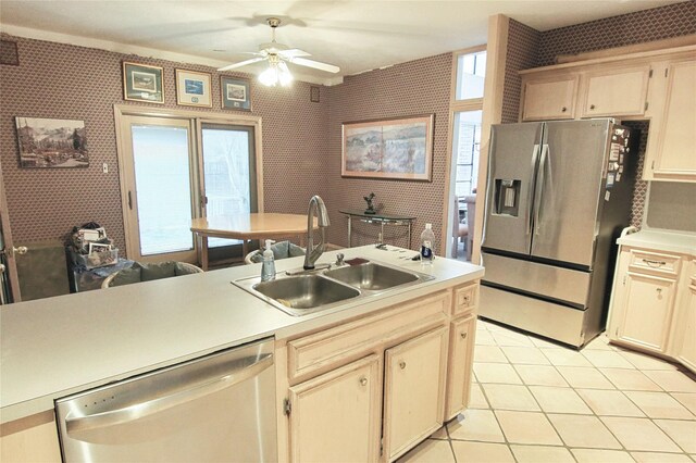 kitchen with light tile patterned flooring, ceiling fan, appliances with stainless steel finishes, and sink