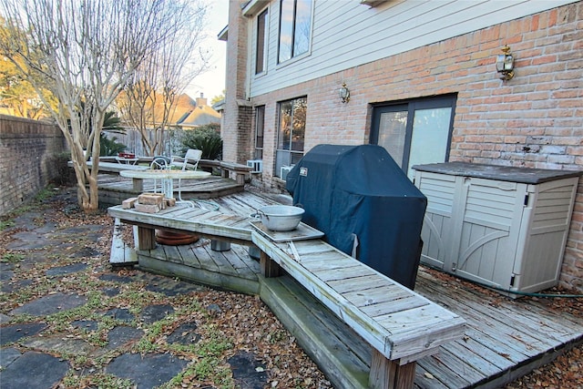 wooden terrace featuring area for grilling