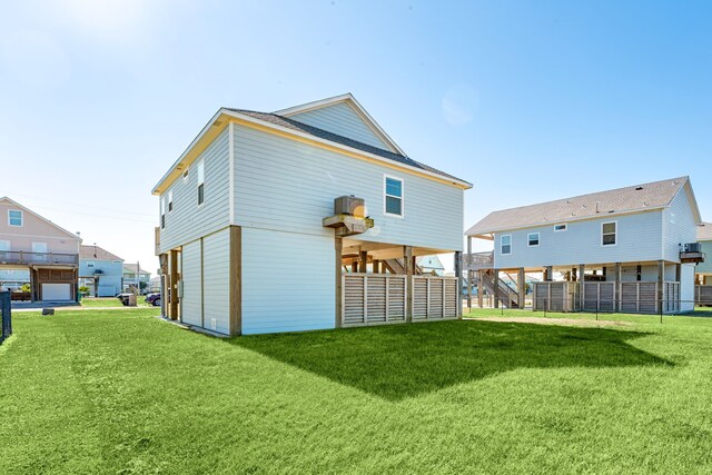 rear view of house featuring a lawn