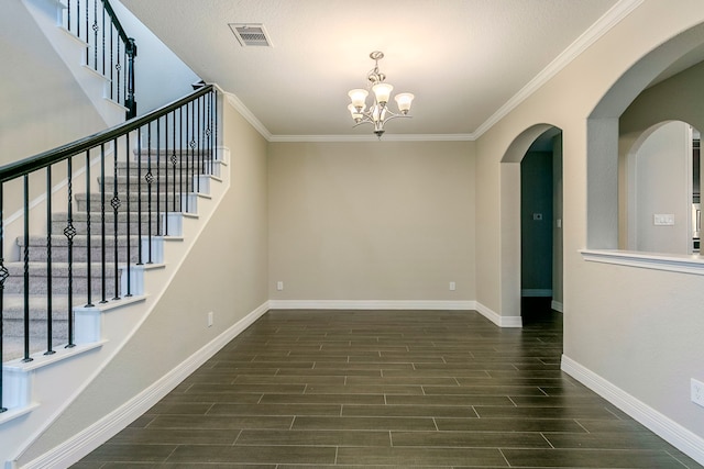 unfurnished room featuring ornamental molding and a chandelier