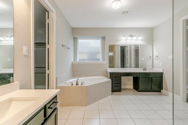 bathroom featuring separate shower and tub, vanity, and tile patterned flooring