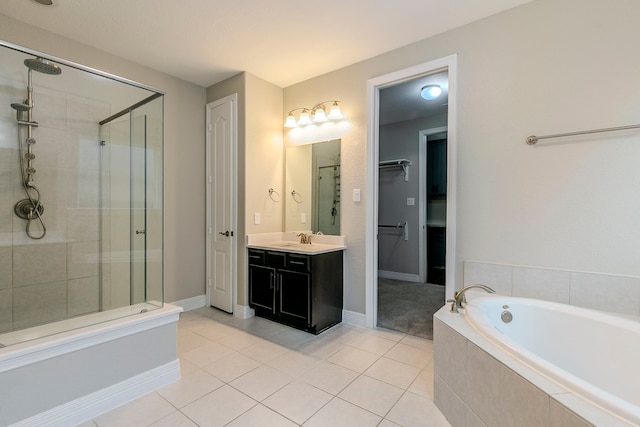 bathroom featuring plus walk in shower, tile patterned floors, and vanity