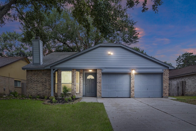 ranch-style house with a yard and a garage