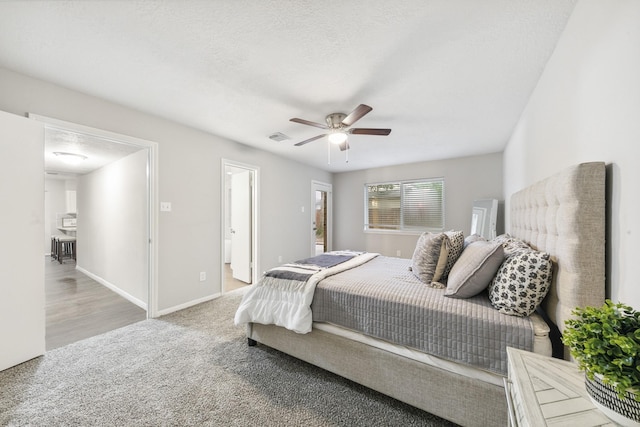 bedroom featuring ceiling fan and ensuite bath