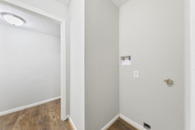 clothes washing area featuring dark wood-type flooring and hookup for a washing machine