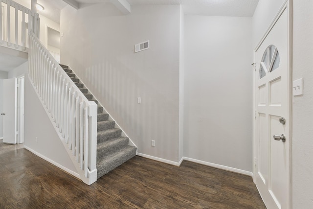 stairway with vaulted ceiling with beams and hardwood / wood-style floors