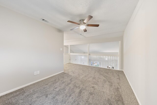 spare room featuring a textured ceiling, ceiling fan, and carpet floors