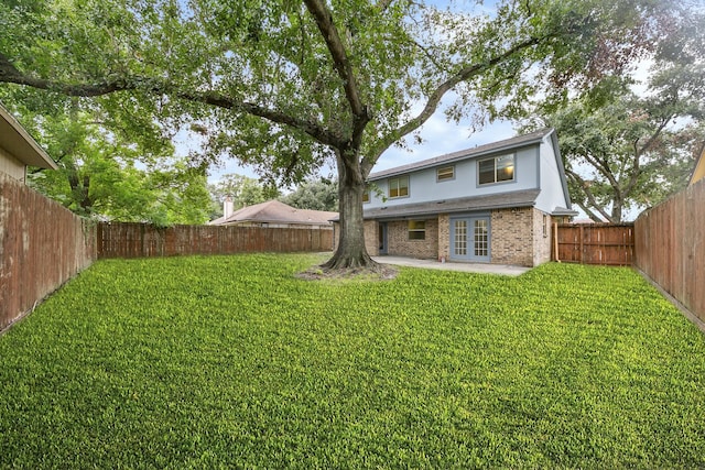 view of yard featuring a patio area and french doors