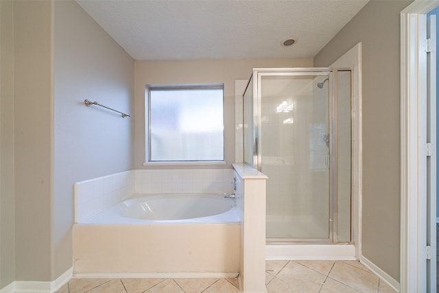 bathroom featuring tile patterned floors, a textured ceiling, and shower with separate bathtub