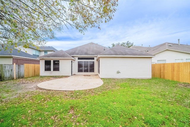 back of property featuring a patio area and a lawn