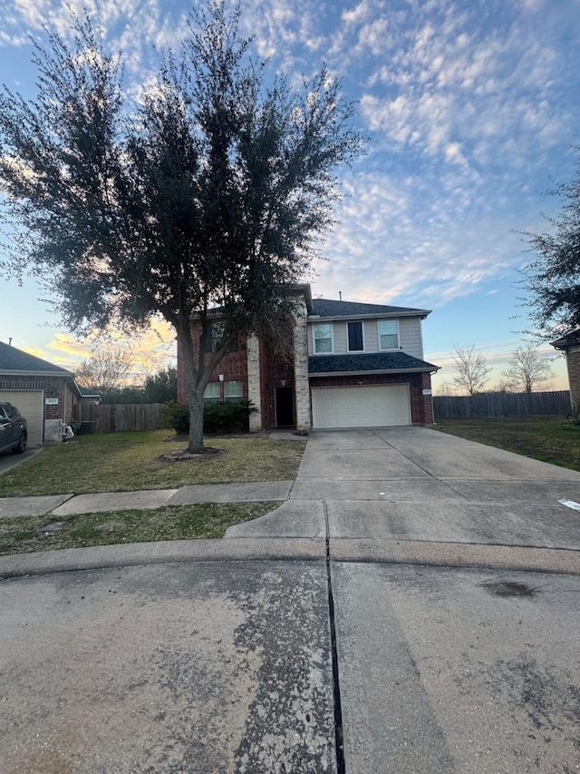 view of front of home with a lawn and a garage