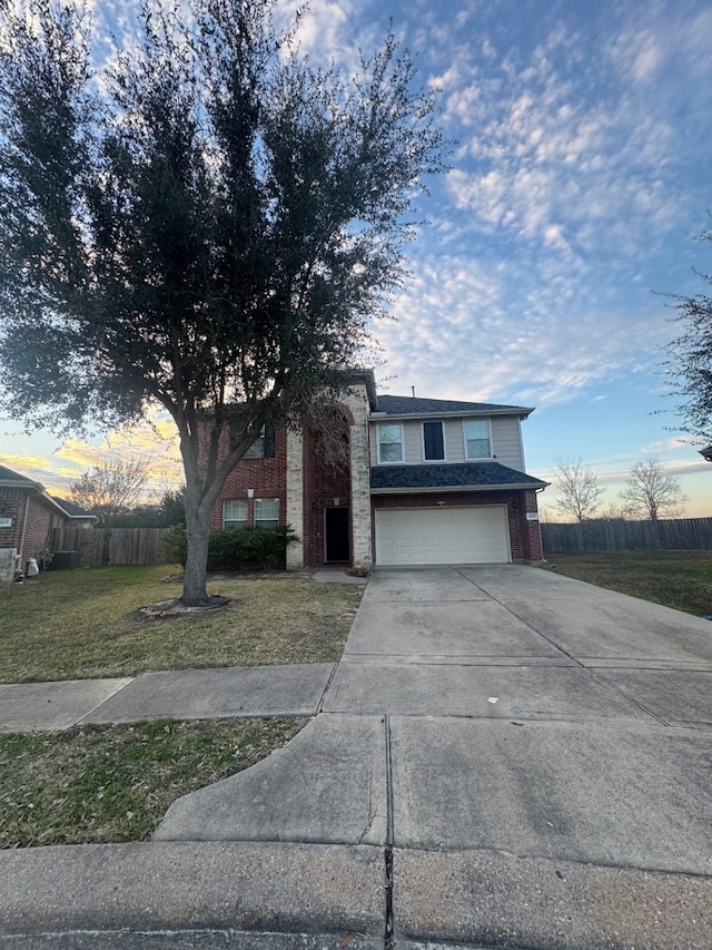 view of front of house with a garage and a lawn