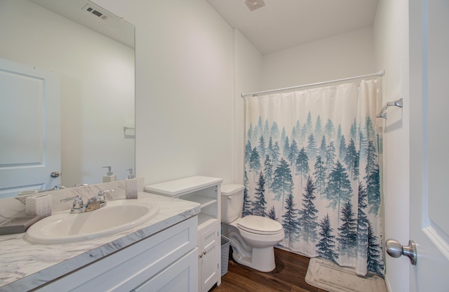 bathroom featuring wood-type flooring, toilet, vanity, and a shower with curtain