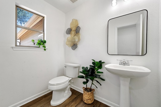 bathroom featuring toilet and hardwood / wood-style floors