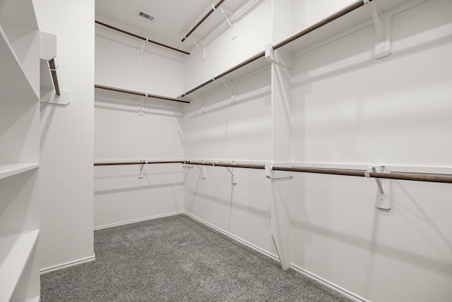 spacious closet with visible vents and dark carpet