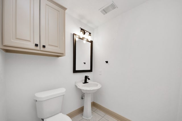 bathroom featuring toilet and tile patterned floors