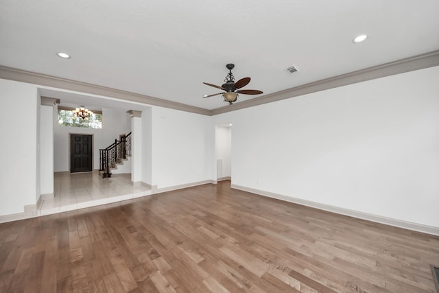 unfurnished living room with ceiling fan, crown molding, and light hardwood / wood-style floors