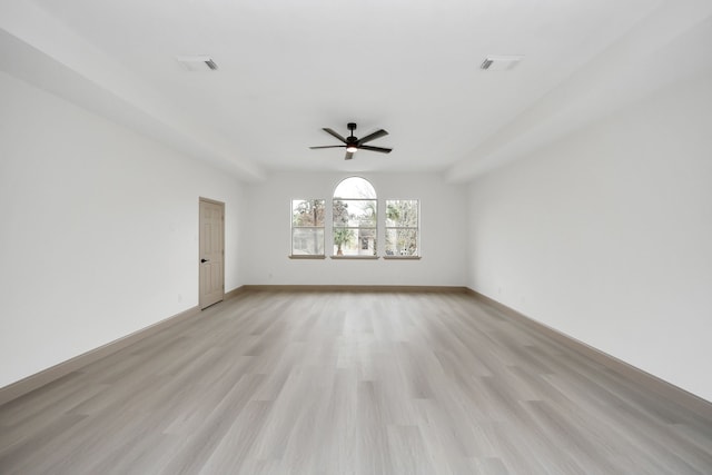 spare room with light wood-type flooring and ceiling fan