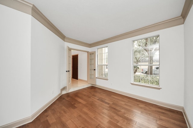 spare room with crown molding and hardwood / wood-style floors