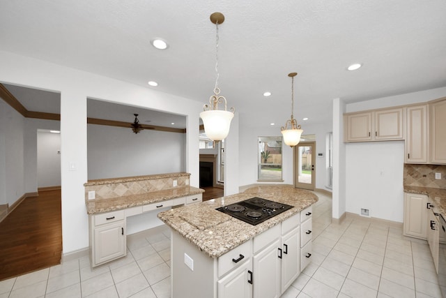 kitchen featuring a kitchen island, decorative backsplash, light tile patterned flooring, hanging light fixtures, and black electric cooktop