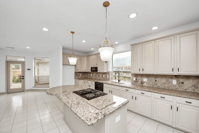 kitchen with black appliances, a kitchen island, decorative light fixtures, decorative backsplash, and sink