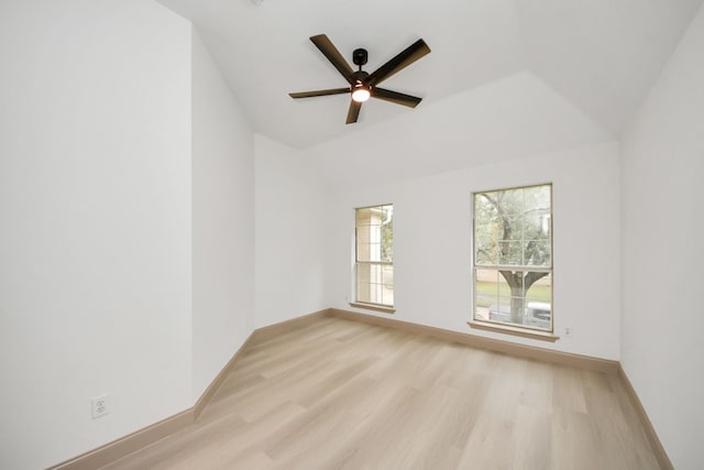 empty room with ceiling fan, lofted ceiling, and light wood-type flooring